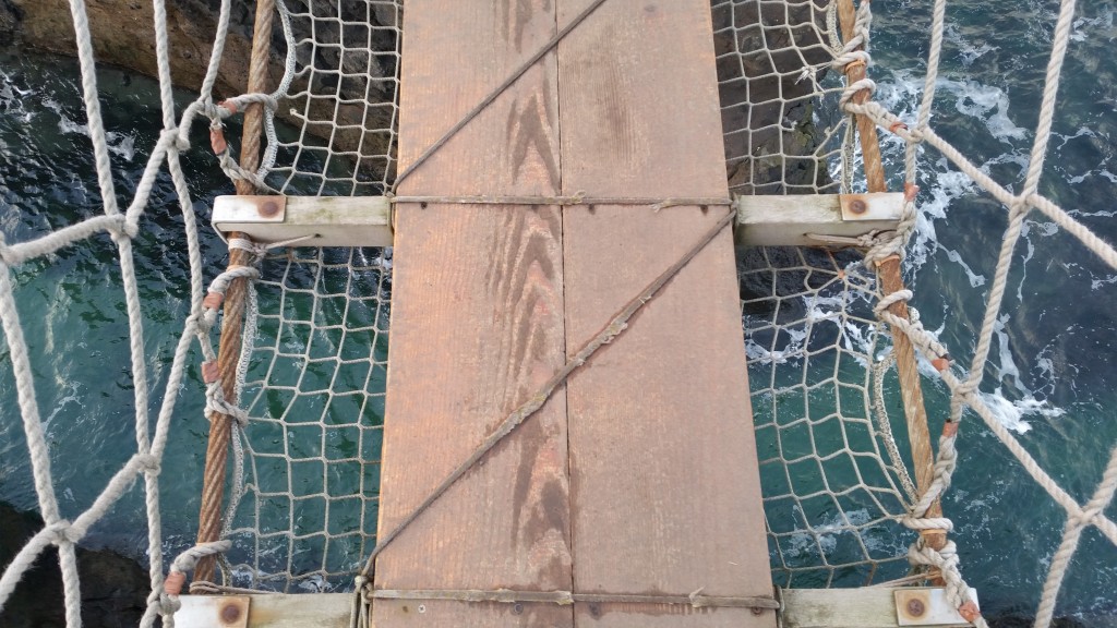 Looking down through the rope bridge, tour to the giants causeway from Dublin